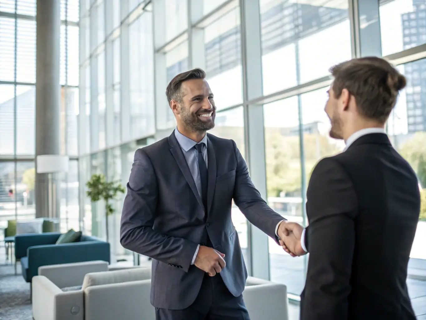 An image showing a successful small business owner shaking hands with a loan officer, symbolizing successful loan approval and business growth.